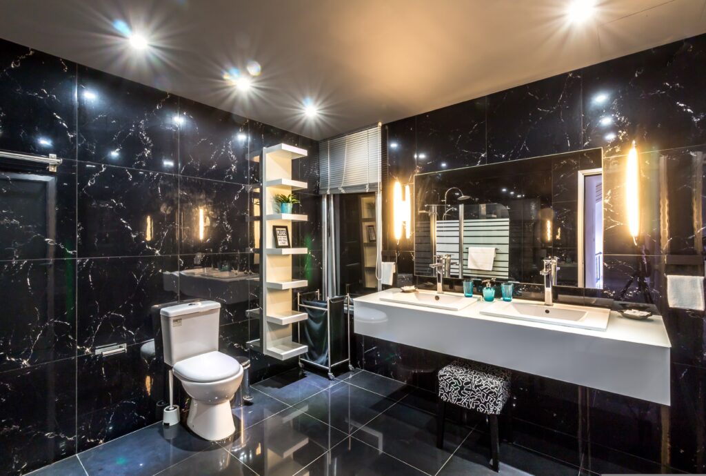 Luxury bathroom with black marble walls and dual sinks.